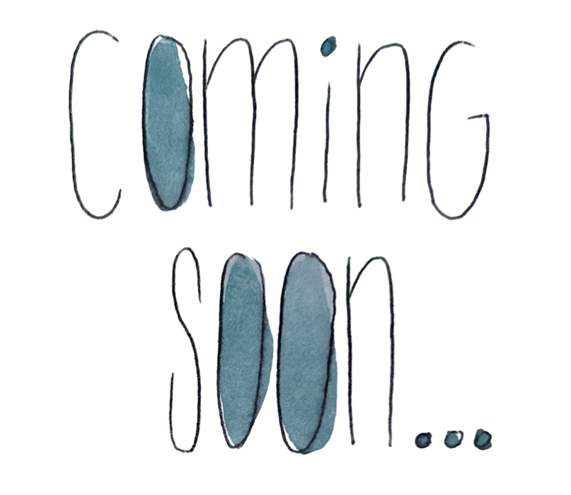 Text 'Coming soon' with blue ink blotches on a white background